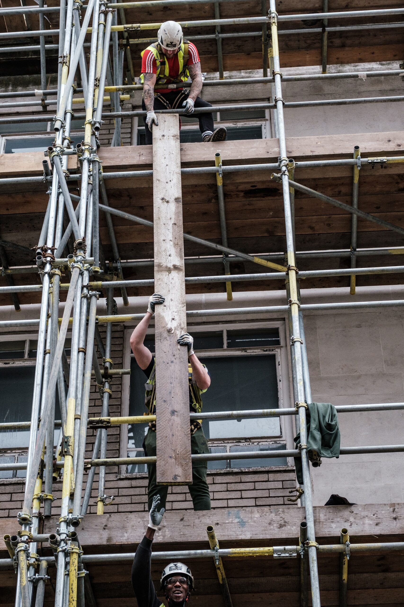 residential scaffolding auckland workers passing down timber